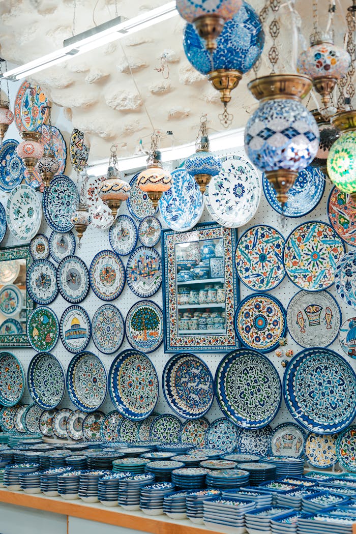 about-us Beautiful ceramic plates and lamps on display at a Jerusalem market shop. Vibrant colors and intricate designs.